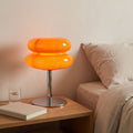 Stacked Bubble Acrylic Table Lamp in orange on a timber bedside table