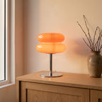 Orange stacked bubble table lamp on an oak entryway sideboard
