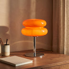 Orange stacked bubble table lamp on a walnut home office desk
