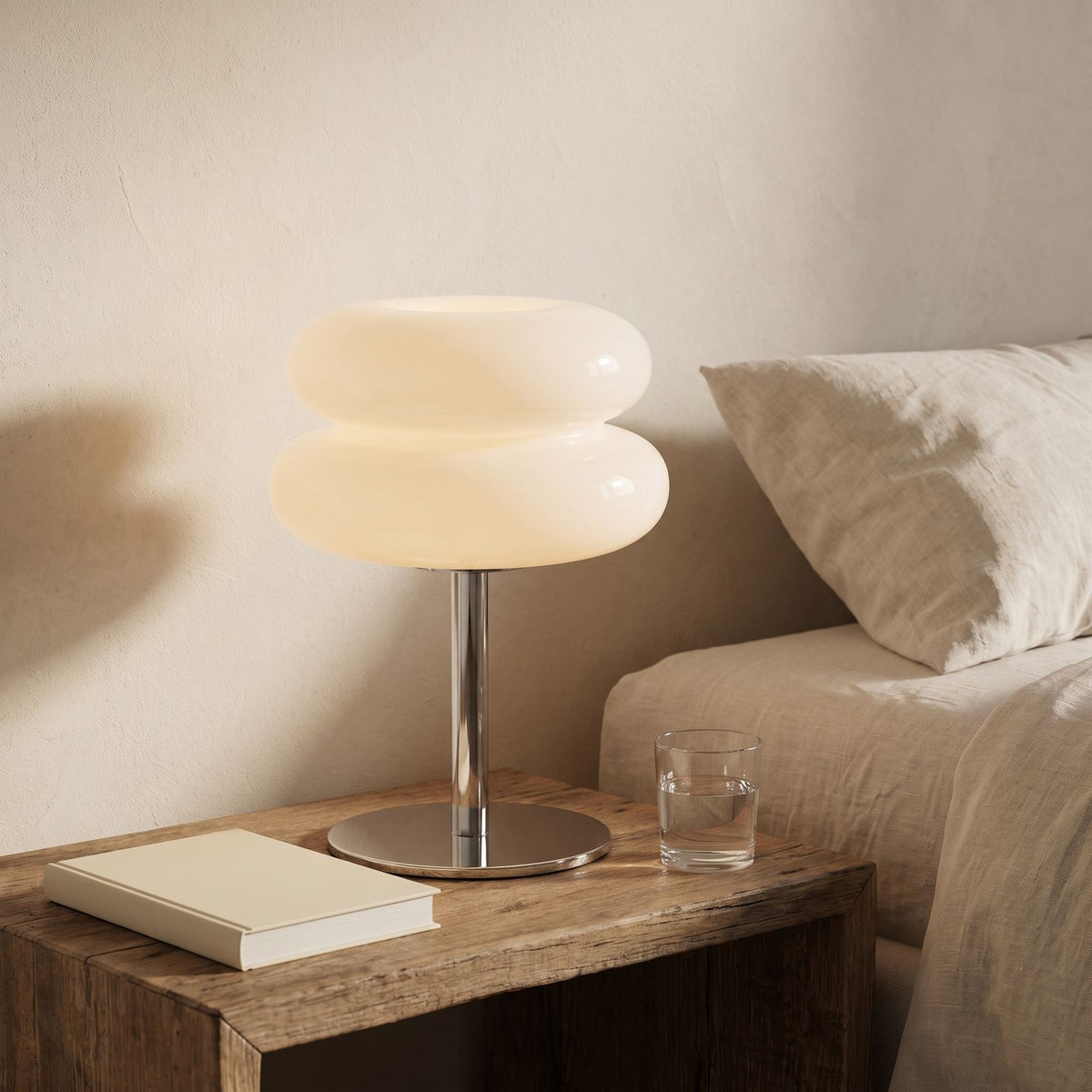 Stacked Bubble Acrylic Table Lamp in white on a bedside table