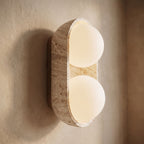 Stacked Frosted Globe Travertine Wall Light, close view at 45 degrees on a plaster wall