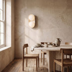 Stacked Frosted Globe Travertine Wall Light on a dining room wall