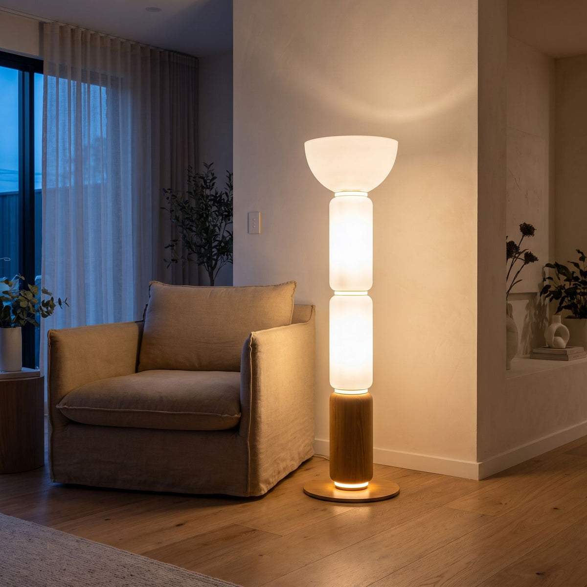 Stacked Glass Capsule Bowl Shade LED Floor Lamp beside an armchair in a living room corner