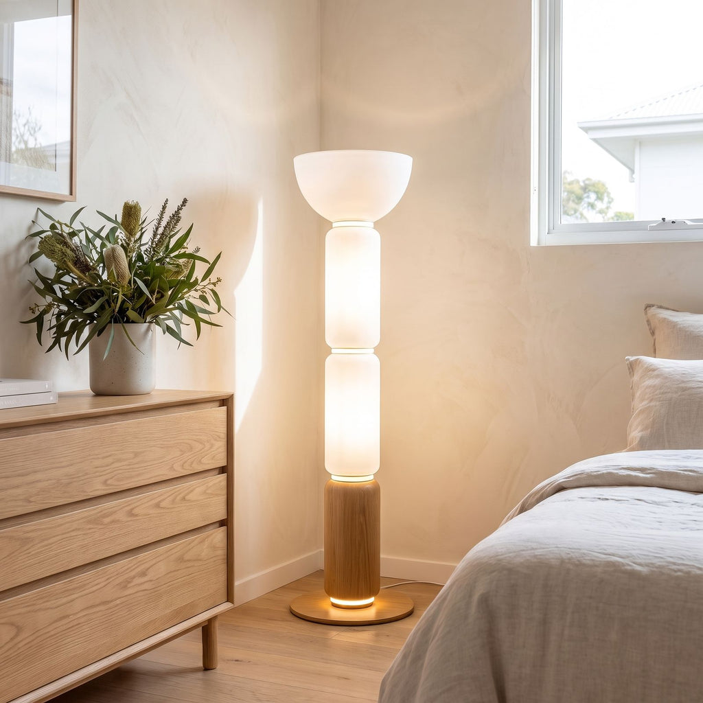 Stacked glass capsule floor lamp in a bedroom corner in daylight