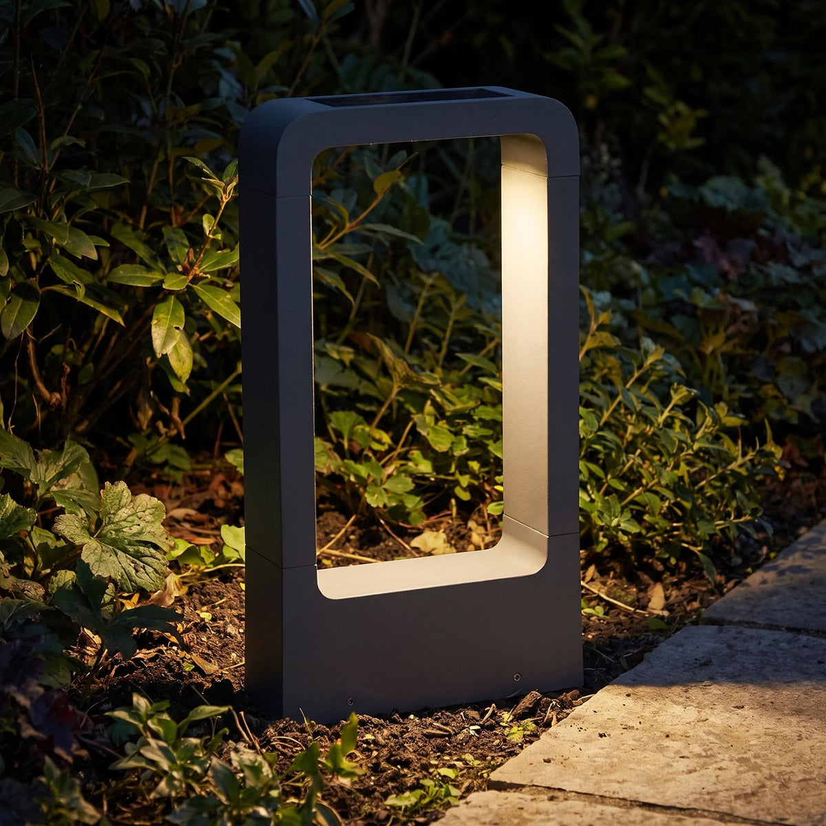 Stainless Steel Solar Floor Light glowing in the garden at night