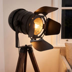 Close-up of the black spotlight head, barn doors and wooden tripod top