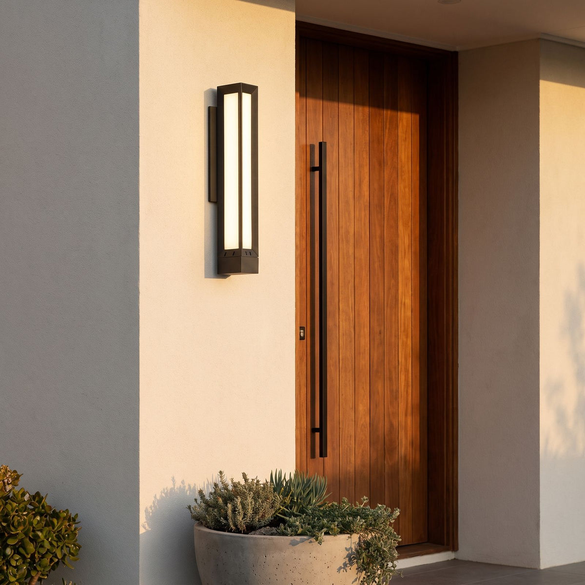 Tall Black Frame LED Outdoor Wall Light beside a timber front door at dusk