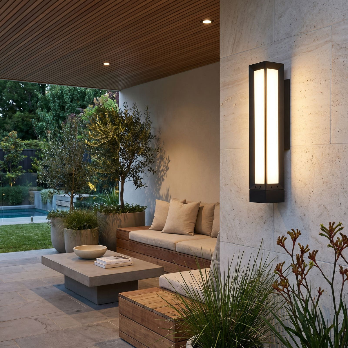 Tall Black Frame LED Outdoor Wall Light on a limestone wall in a covered outdoor living area