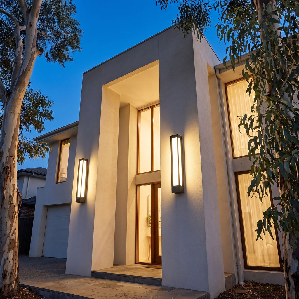 Two Tall Black Frame LED Outdoor Wall Lights on a double height facade at blue hour