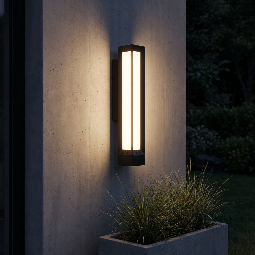 Tall Black Frame LED Outdoor Wall Light lighting a concrete wall at night