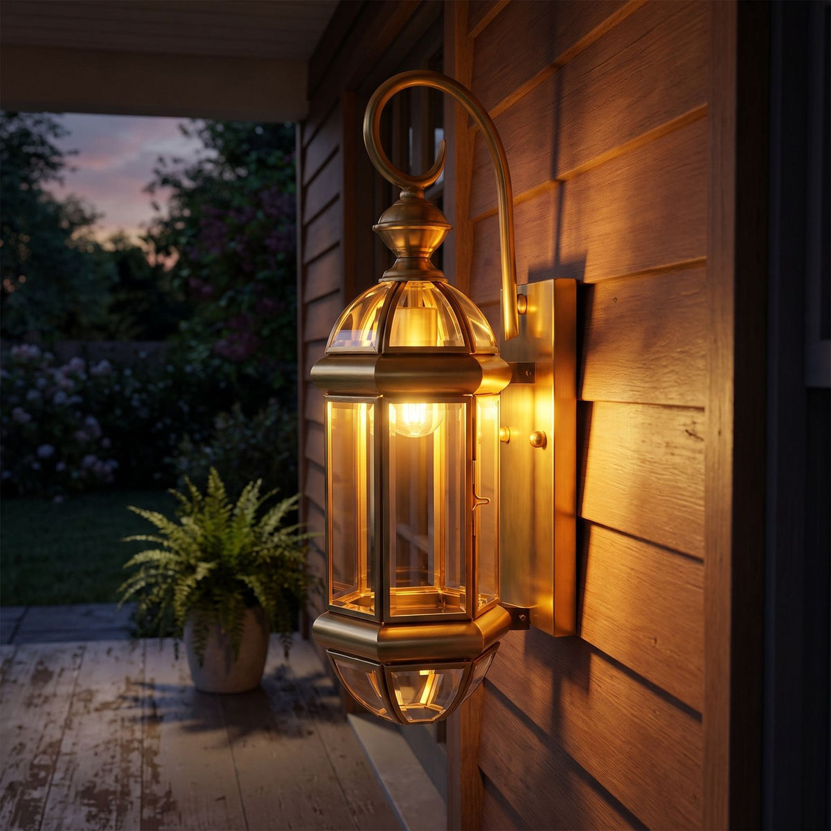 Tall Brass and Clear Glass Outdoor Wall Lantern on a porch wall at dusk