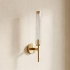 Tall Brass and Textured Glass Wall Sconce, close view at 45 degrees on a plaster wall