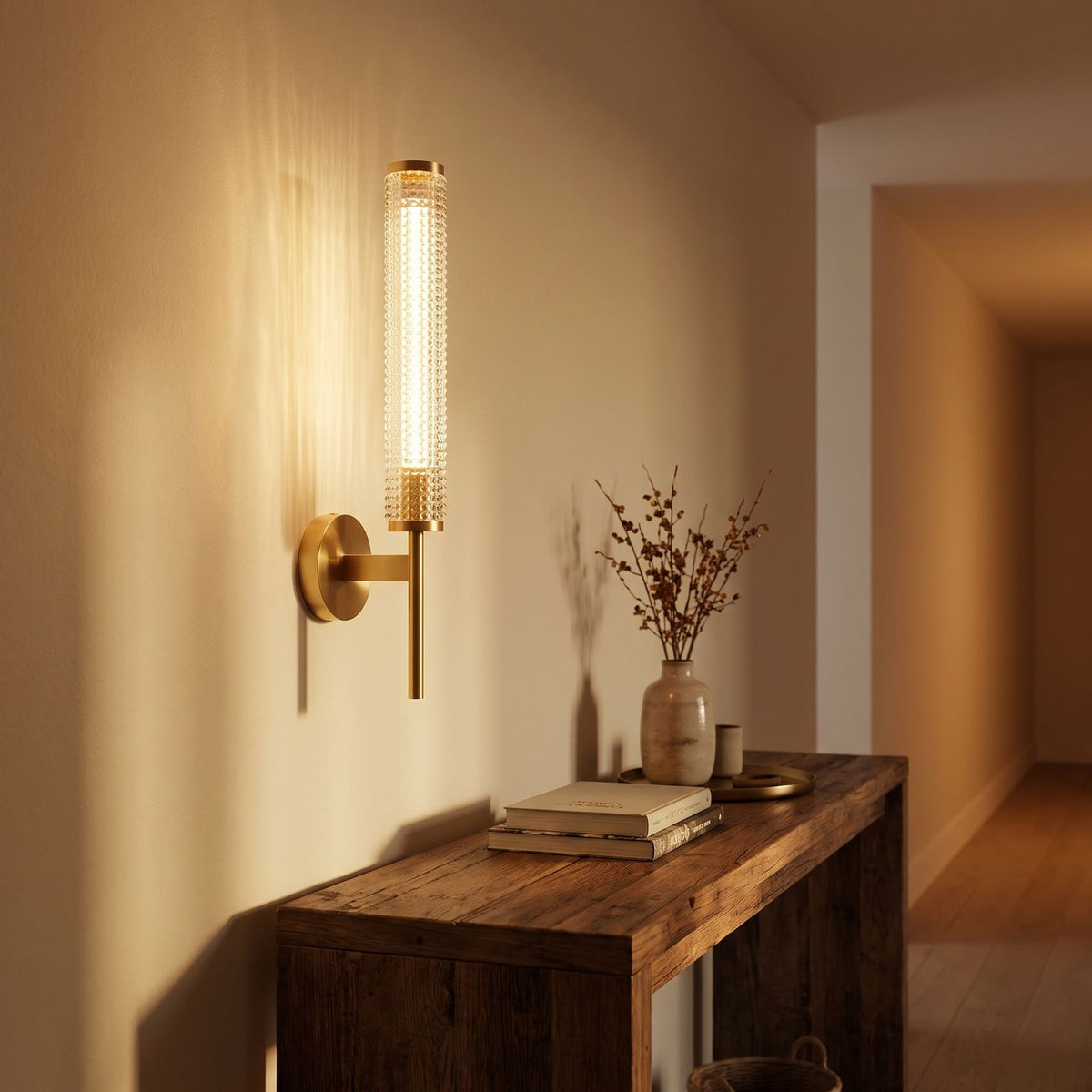 Tall Brass and Textured Glass Wall Sconce in a hallway above a timber console