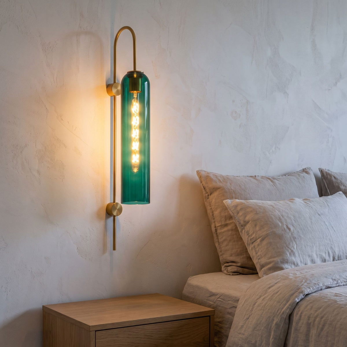 Tall Hook Arm Glass Cylinder Wall Light beside a bed