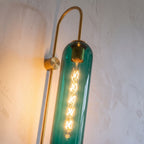 Close-up of the glass cylinder and gold hook