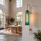 Tall Hook Arm Glass Cylinder Wall Light on a dining room wall