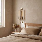 Tall Ribbed Glass and Brass Column Wall Light on a bedroom wall beside the bed