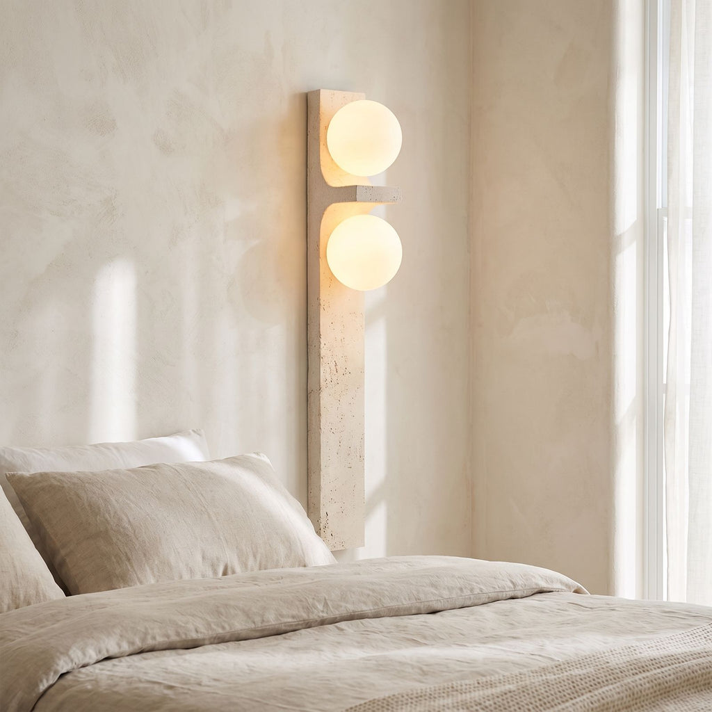 Tall Slim Travertine Strip Wall Light on a bedroom wall beside the bed