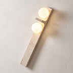 Tall Slim Travertine Strip Wall Light, close view at 45 degrees on a plaster wall
