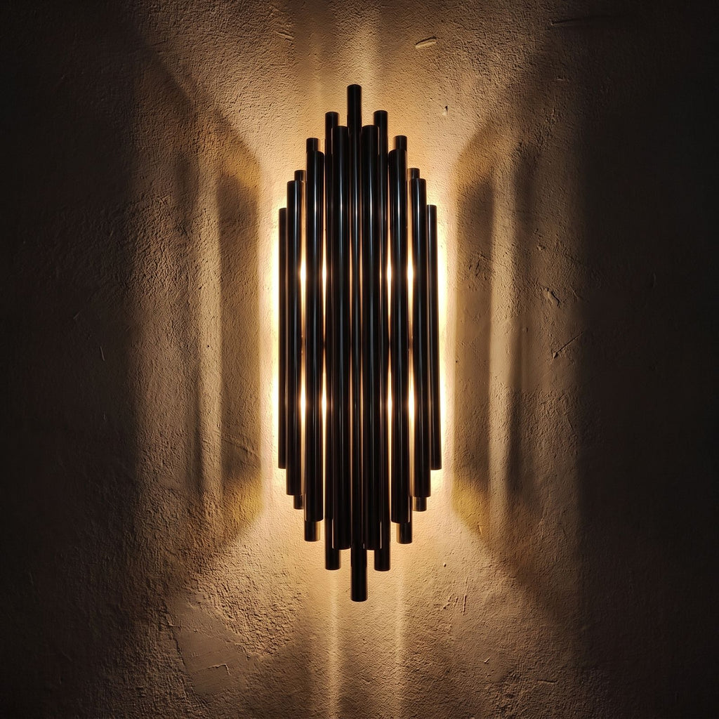 Tall Stainless Steel Up and Down Wall Light glowing on a plaster wall at night