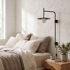 Tall Swing Arm Globe Plug-In Wall Light on a bedroom wall beside the bed