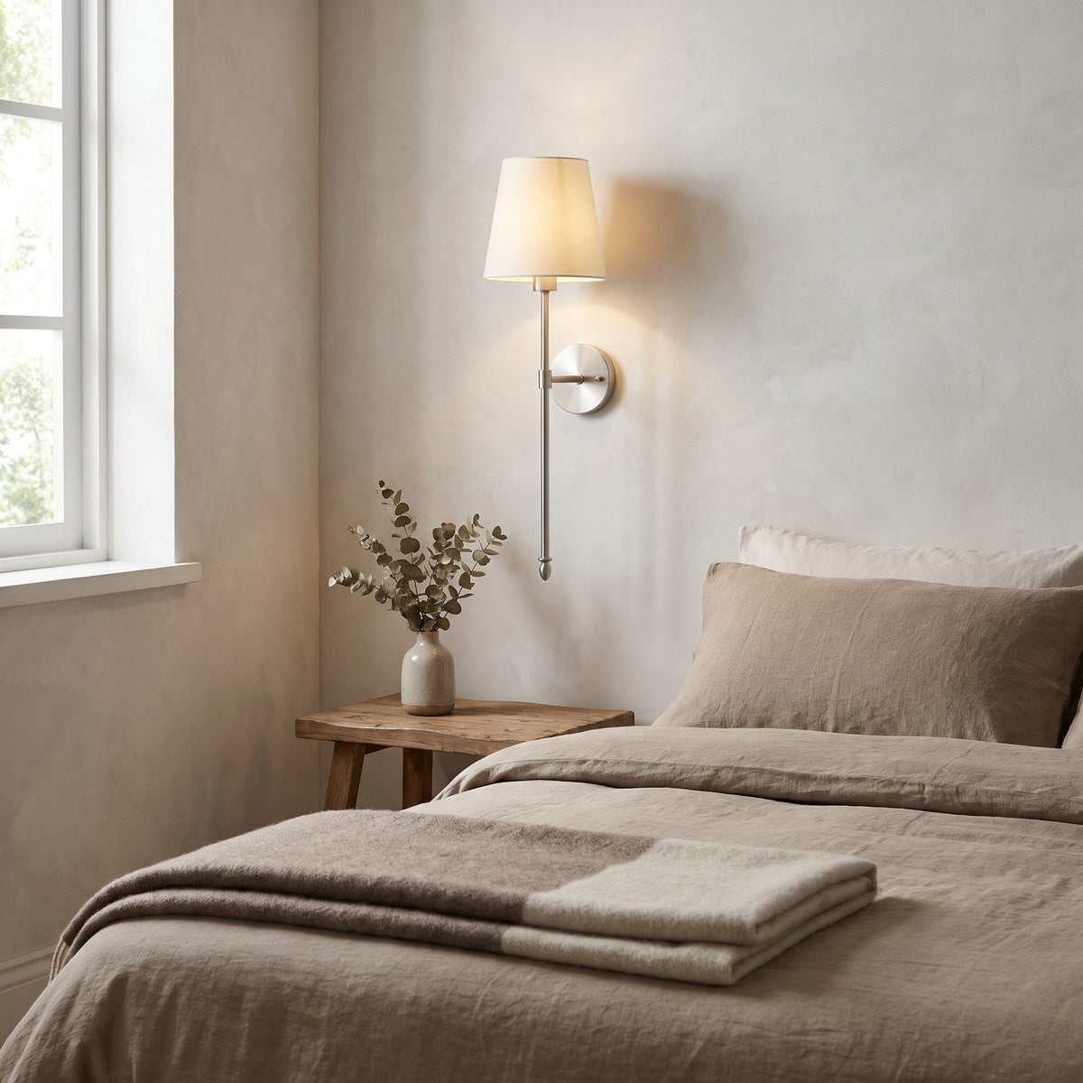 Tapered Fabric Shade Wireless Wall Sconce in silver on a bedroom wall above the timber bedside table