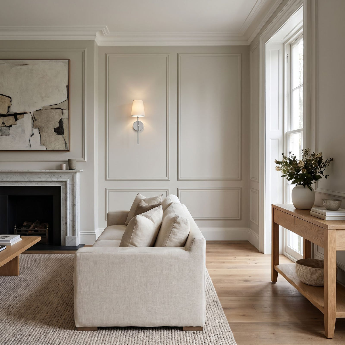 Tapered Fabric Shade Wireless Wall Sconce in silver on a panelled living room wall beside the sofa