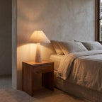 Tapered Travertine Stem Table Lamp on a bedside table
