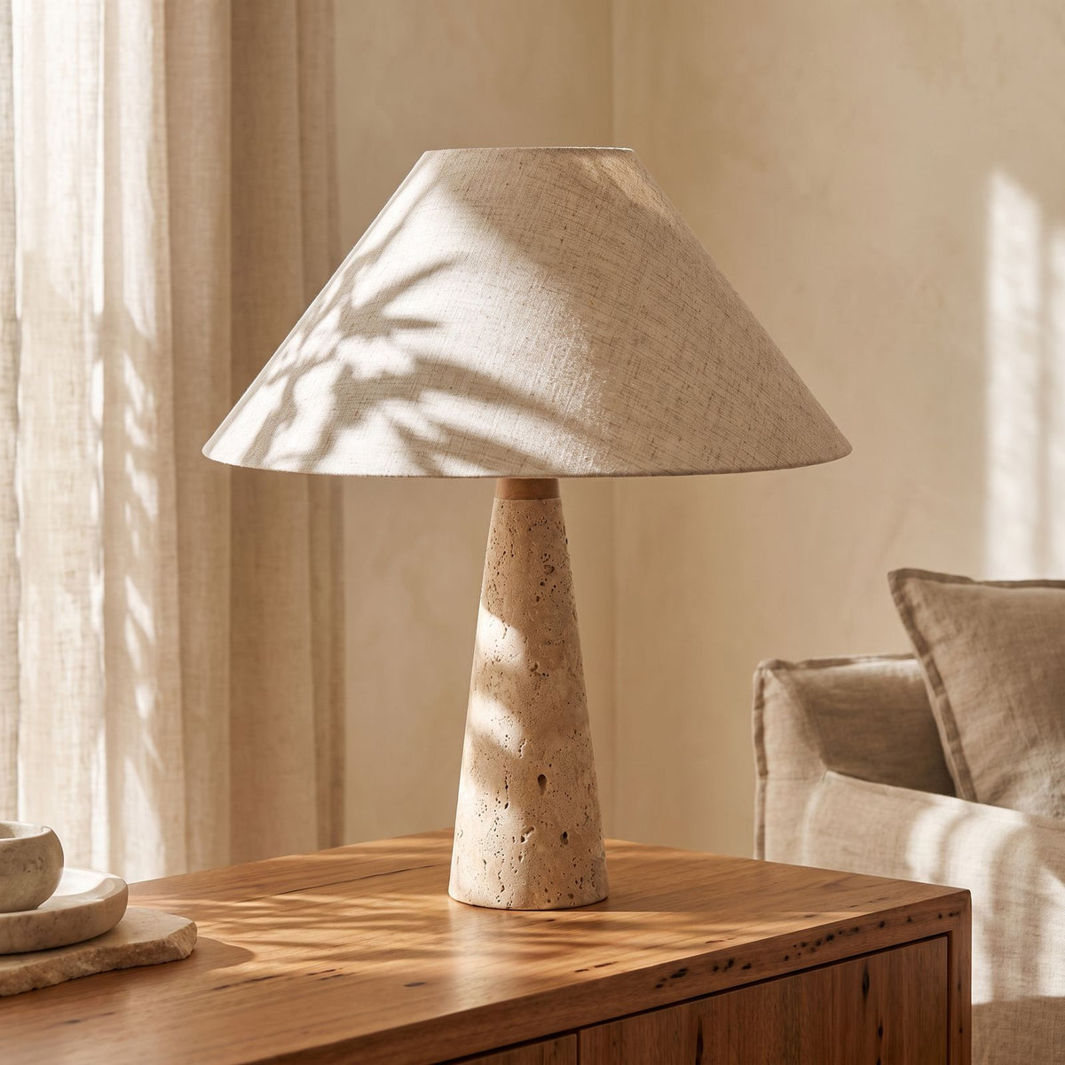 Tapered Travertine Stem Table Lamp, close view on a timber surface