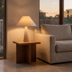 Tapered Travertine Stem Table Lamp on a side table beside a sofa