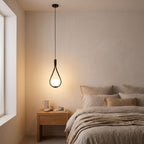 Teardrop Frame White Glass Globe Pendant Light beside a bed