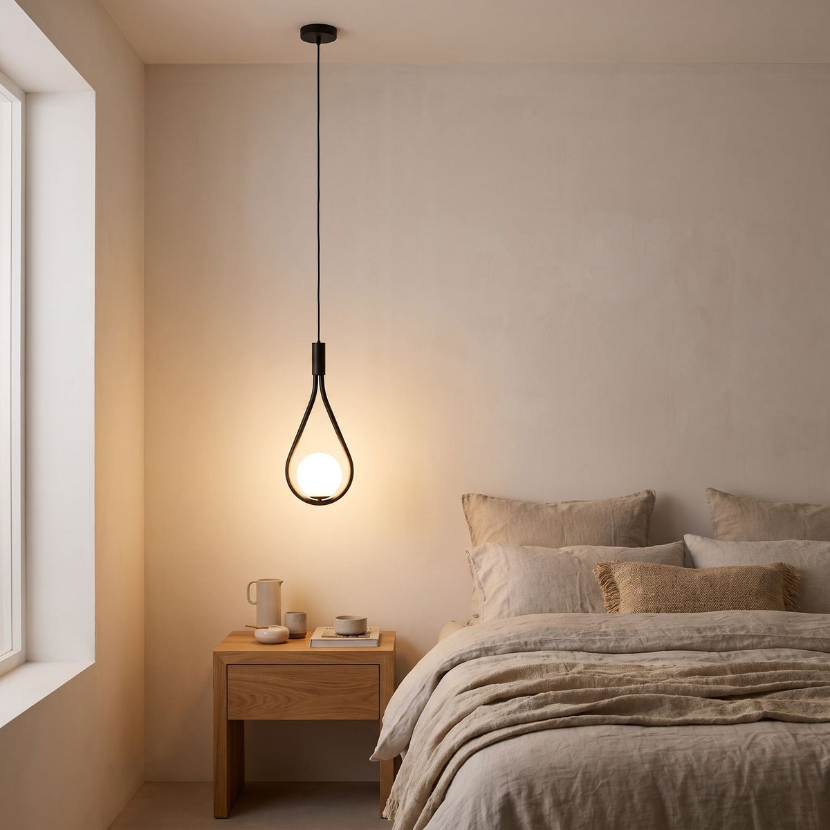 Teardrop Frame White Glass Globe Pendant Light beside a bed
