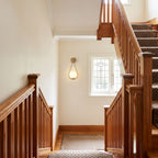 Teardrop Gold Frame Opal Glass Globe Wall Light on a staircase landing wall in a Federation-style hallway in daylight