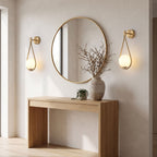 Teardrop Gold Frame Opal Glass Globe Wall Light pair either side of a round mirror above an oak console in an entrance hall