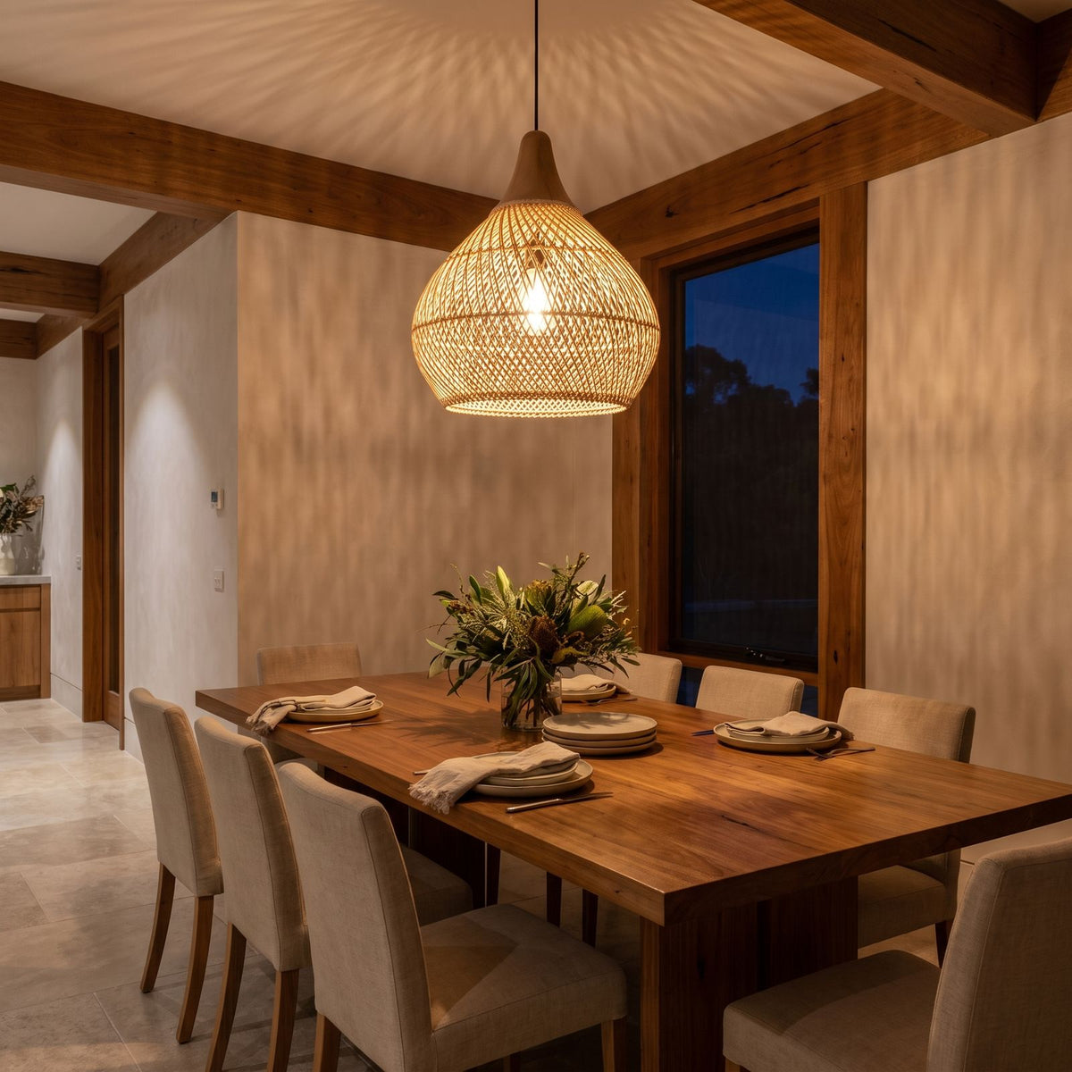 Teardrop Woven Rattan Pendant Light above a timber dining table