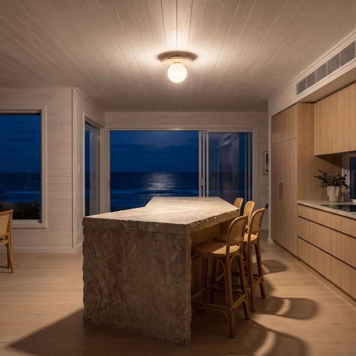 Terrazzo and Opal Glass Globe Flush Mount Ceiling Light above a kitchen island at night