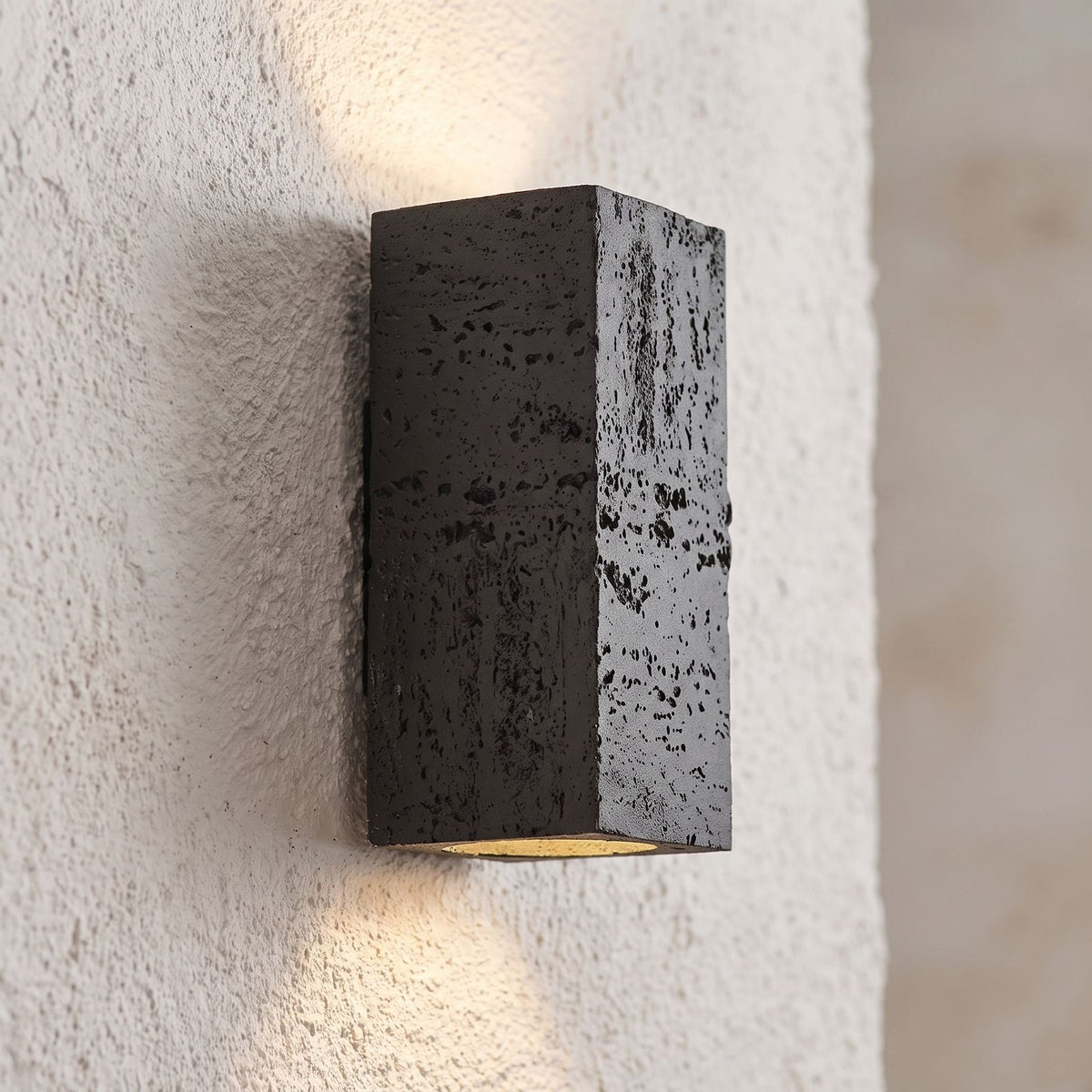 Textured Cement-Finish Box Wall Light, close view at 45 degrees on a plaster wall