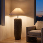 Textured Clay Base Cone Shade Floor Lamp beside an armchair in a living room corner
