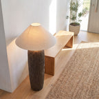 Textured clay base cone shade floor lamp in an entry hall in daylight