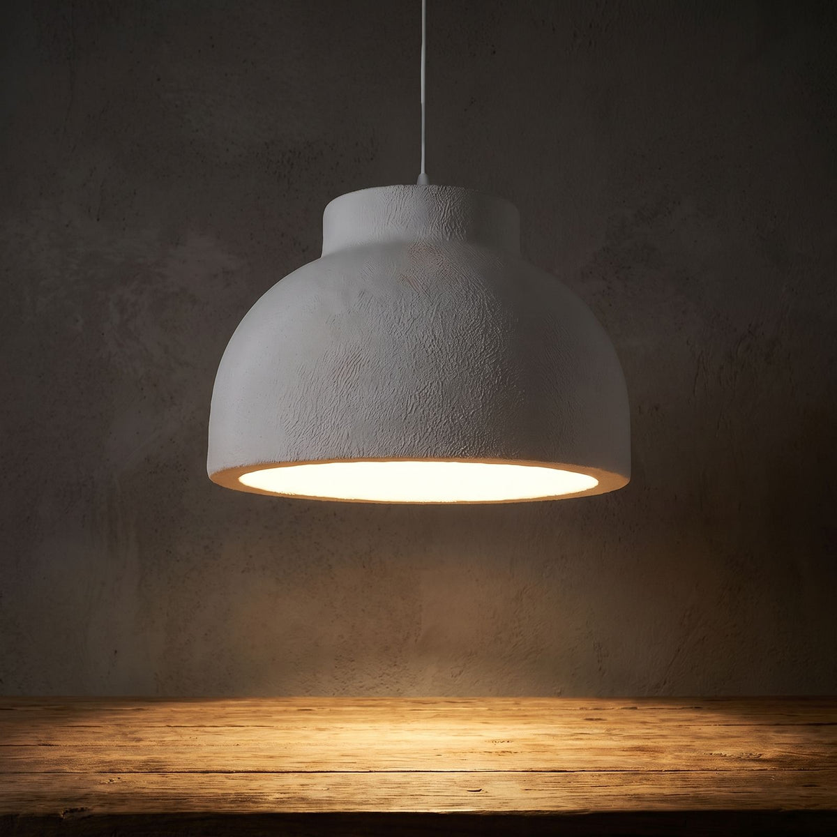 Textured Polystyrene Dome Pendant Light glowing against a plaster wall at night