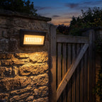 Three Mode Solar Outdoor Wall Light on a porch wall at dusk