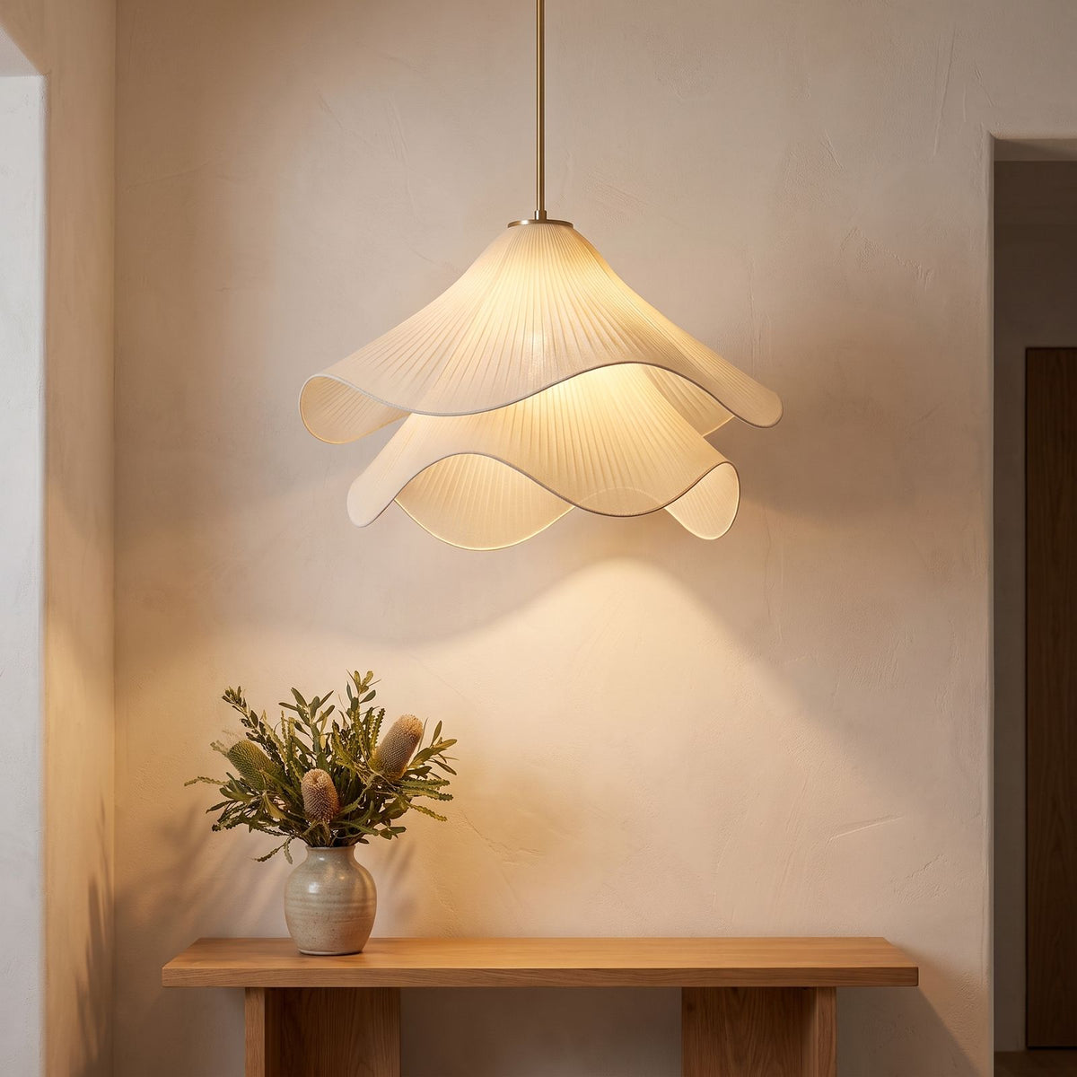 Tiered pleated fabric pendant light above an entry hall console