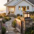 Tiered Roof Black Metal Frosted Acrylic Pillar Light on a gate pillar at the front entrance at golden hour