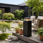 Tiered Roof Black Metal Frosted Acrylic Pillar Light on a timber deck post in daylight