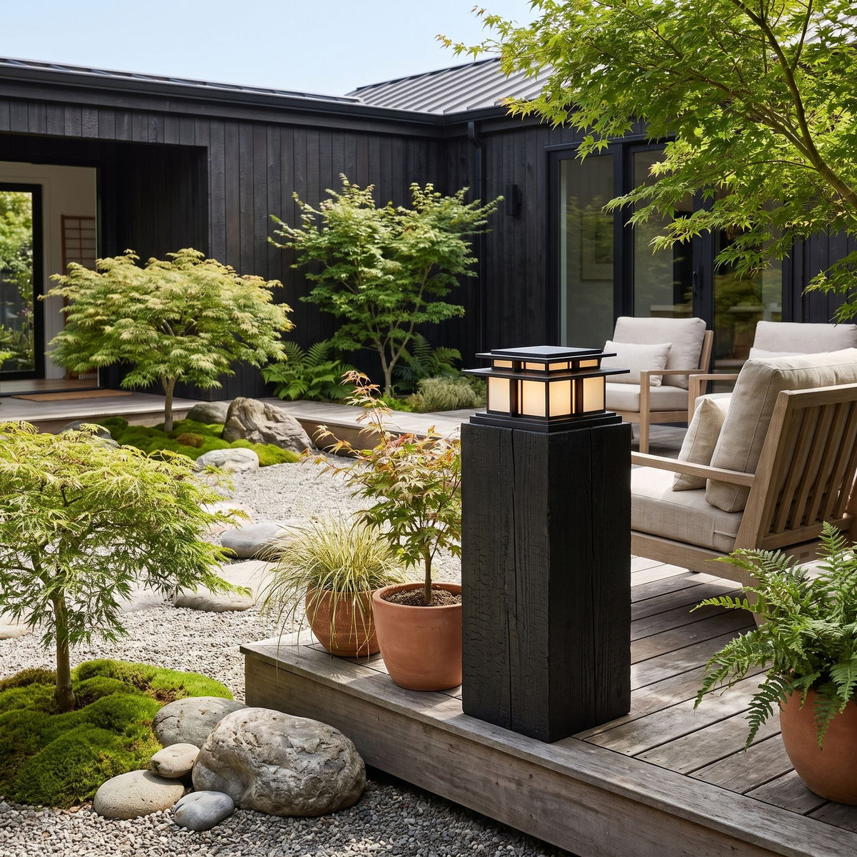 Tiered Roof Black Metal Frosted Acrylic Pillar Light on a timber deck post in daylight