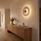 Timber Shade Travertine Wall Light in a hallway above a timber console