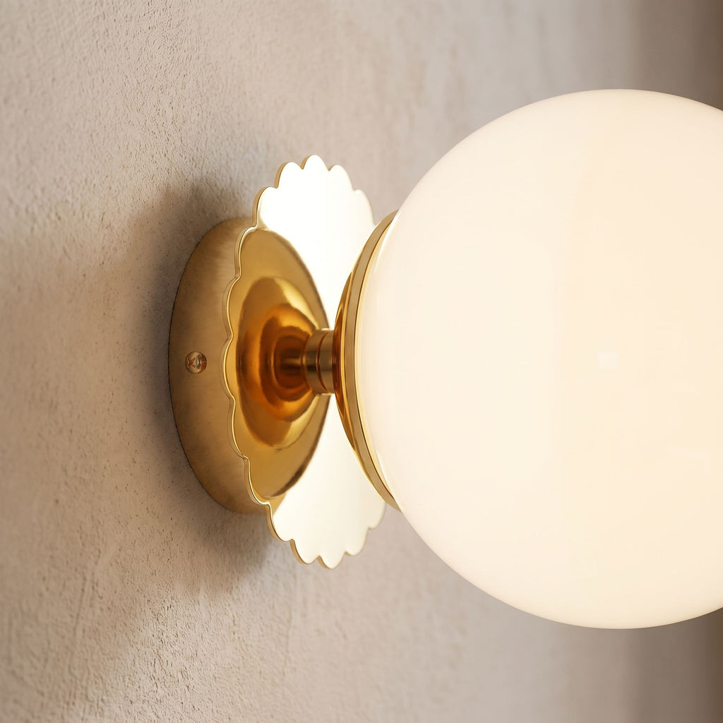 Tinted Glass Ball Up and Down Wall Light, close view at 45 degrees on a plaster wall