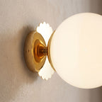 Tinted Glass Ball Up and Down Wall Light, close view at 45 degrees on a plaster wall