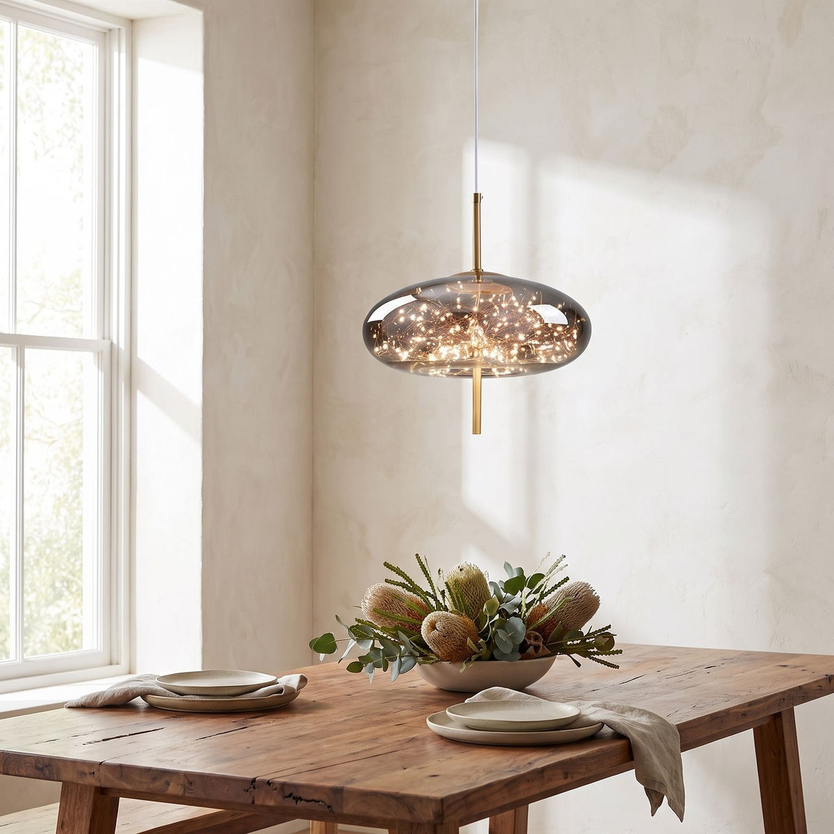 Tinted Glass Capsule and Globe Pendant Light above a timber dining table