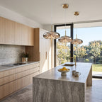 Tinted Glass Capsule and Globe Pendant Light over a stone kitchen island